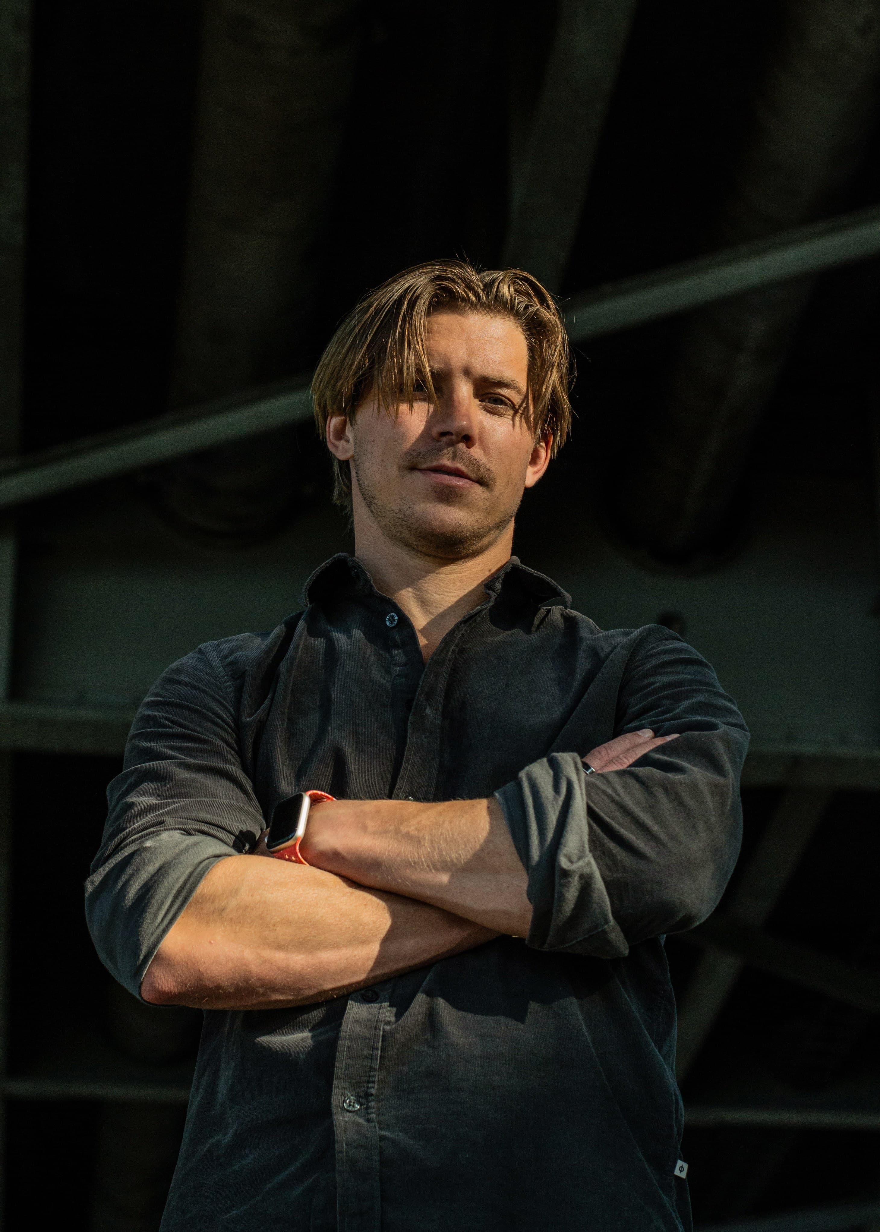 Jakko - arms crossed confident pose with warm lighting